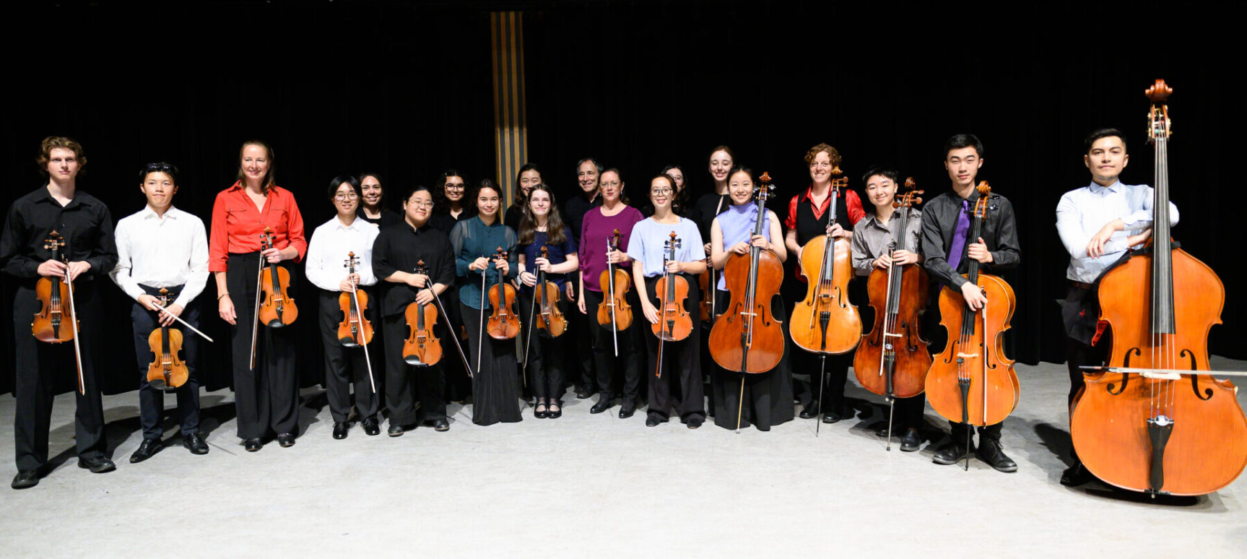 The 2024 Kessler Academy standing after the concert with their instruments.