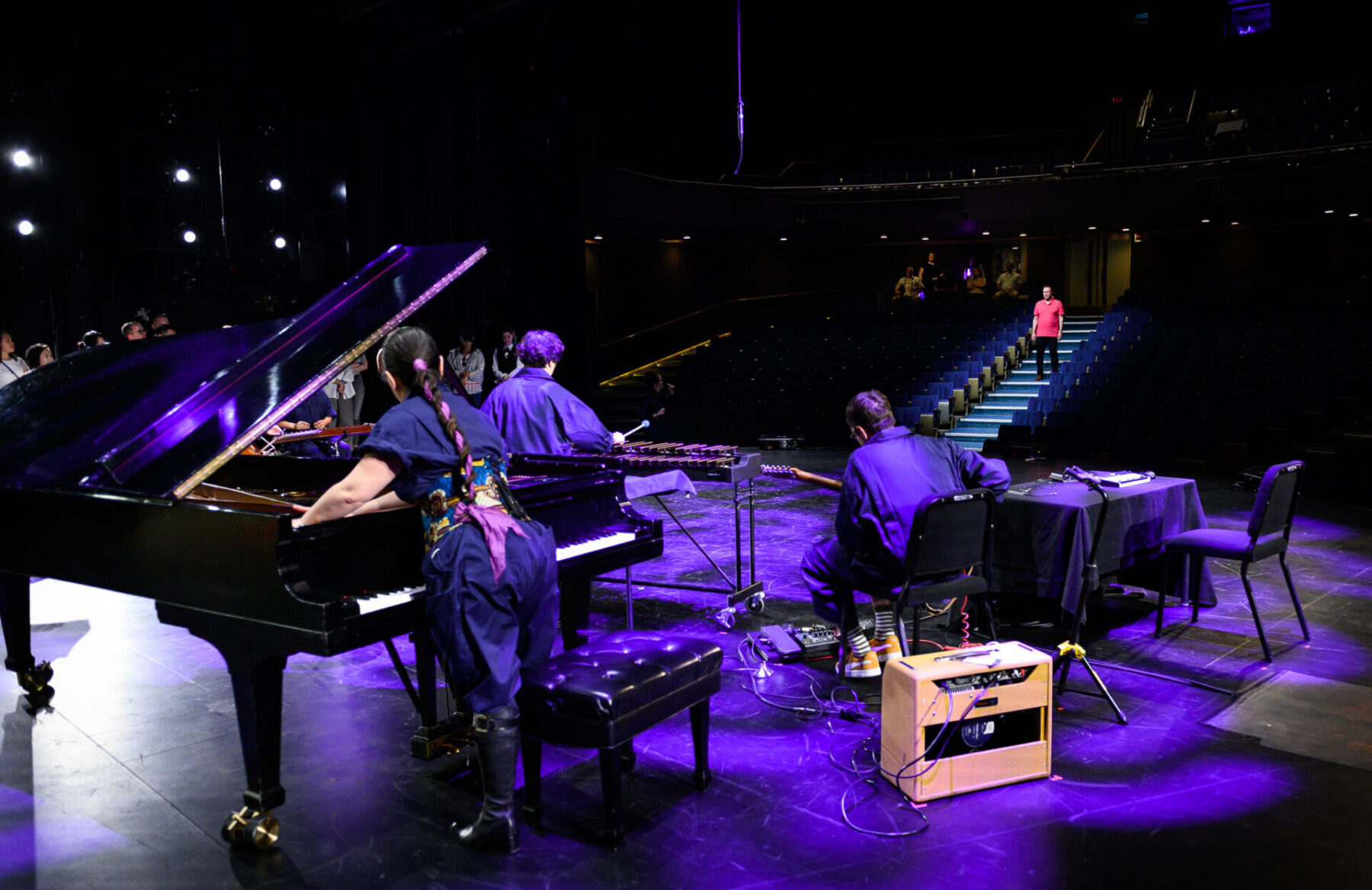 The Tempest Project Company performing on stage, with the camera looking out into the audience.