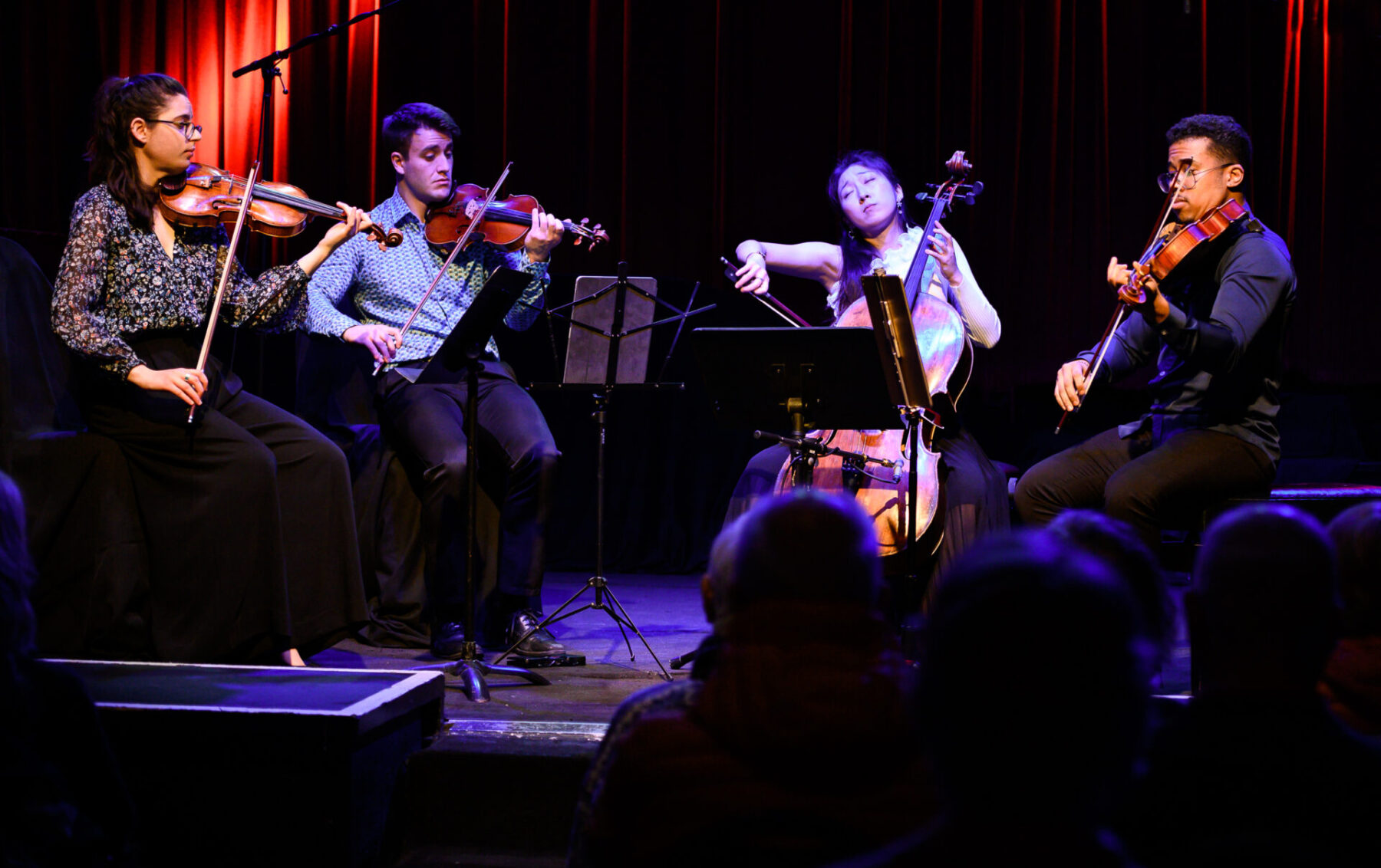 The Dior Quartet sitting on stage performing.